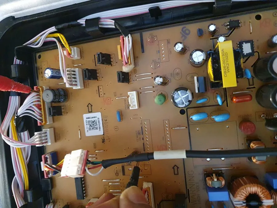 PCB circuit board diagnostic check — technician at work